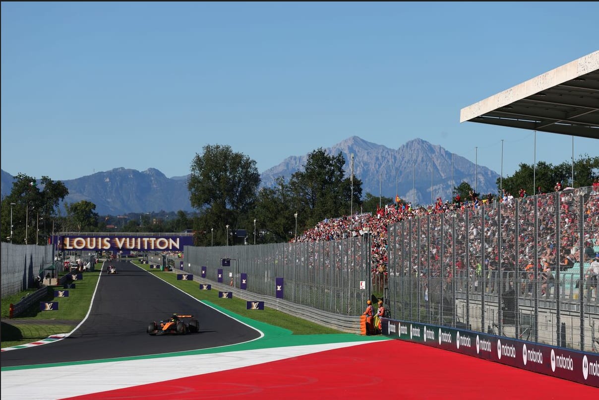 Formula 1 cars racing at the Monza circuit.